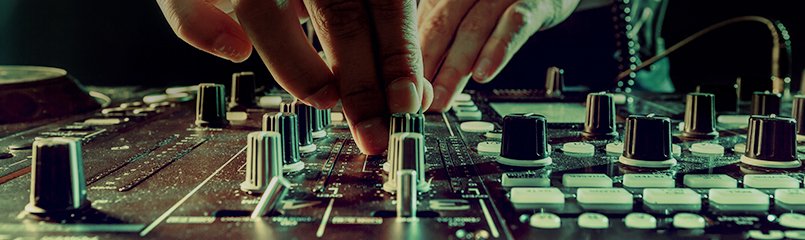 DJ adjusting knobs on sound board