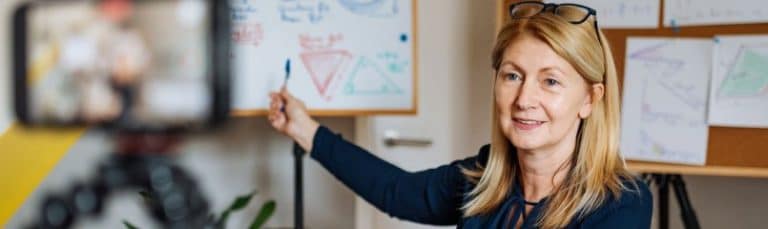 teacher pointing at whiteboard