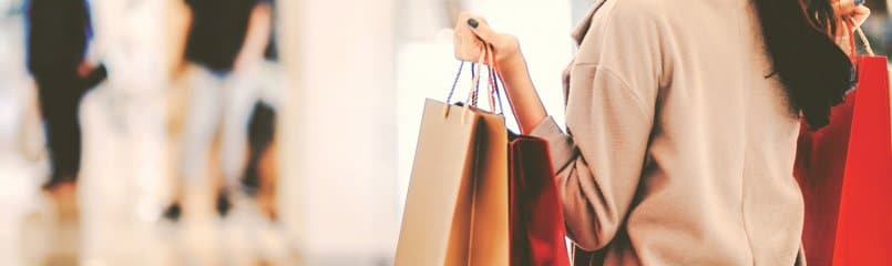 woman holding shopping bags in a mall