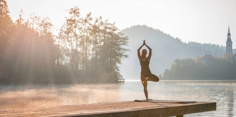 woman doing yoga on a dock