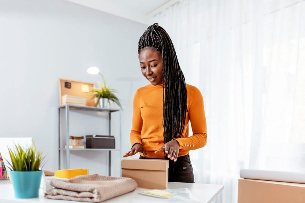 A woman boxes products to sell on Amazon