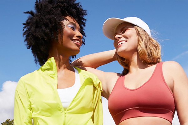 Two friends hanging out in athletic gear.