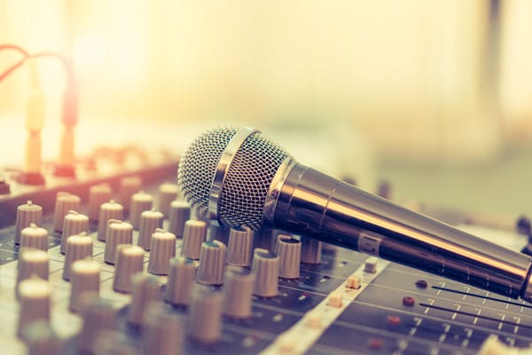 microphone laying across DJ soundboard