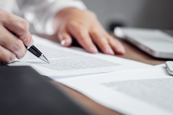 an insurance agent combs through paperwork with with pen