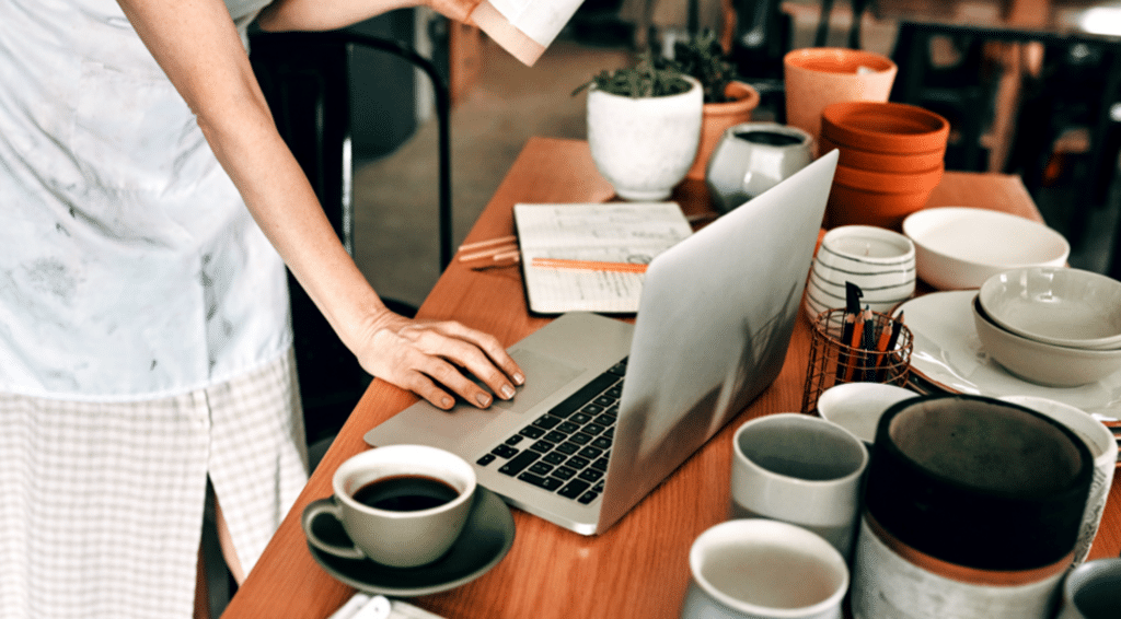 an artist applies for insurance on a laptop.