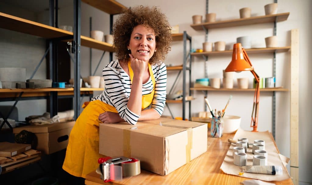 A woman smiles with products.