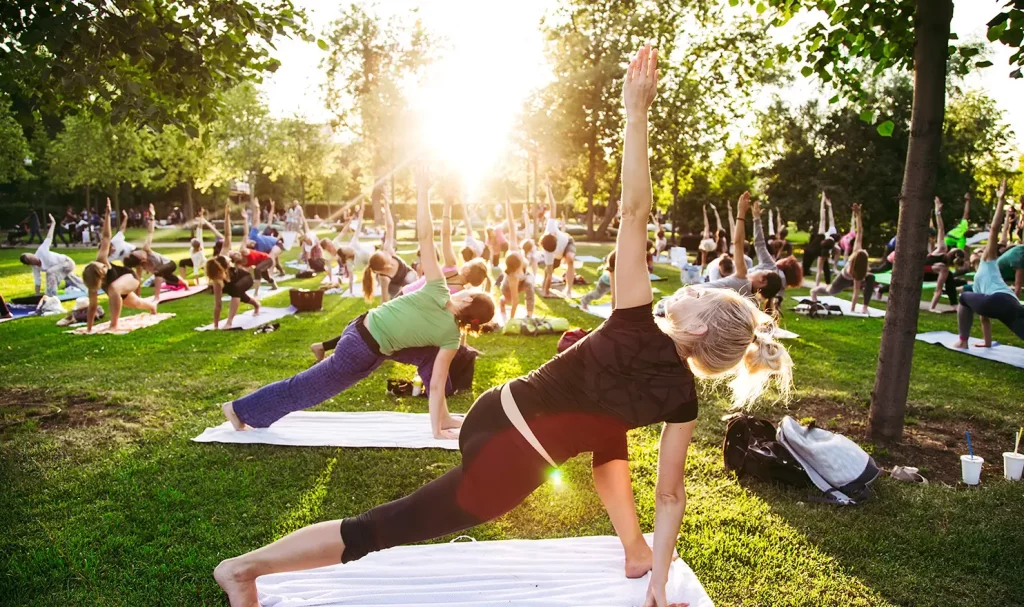 Large Pilates event outside in a park