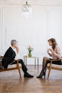 a female life coach is engaged in a conversation with a client