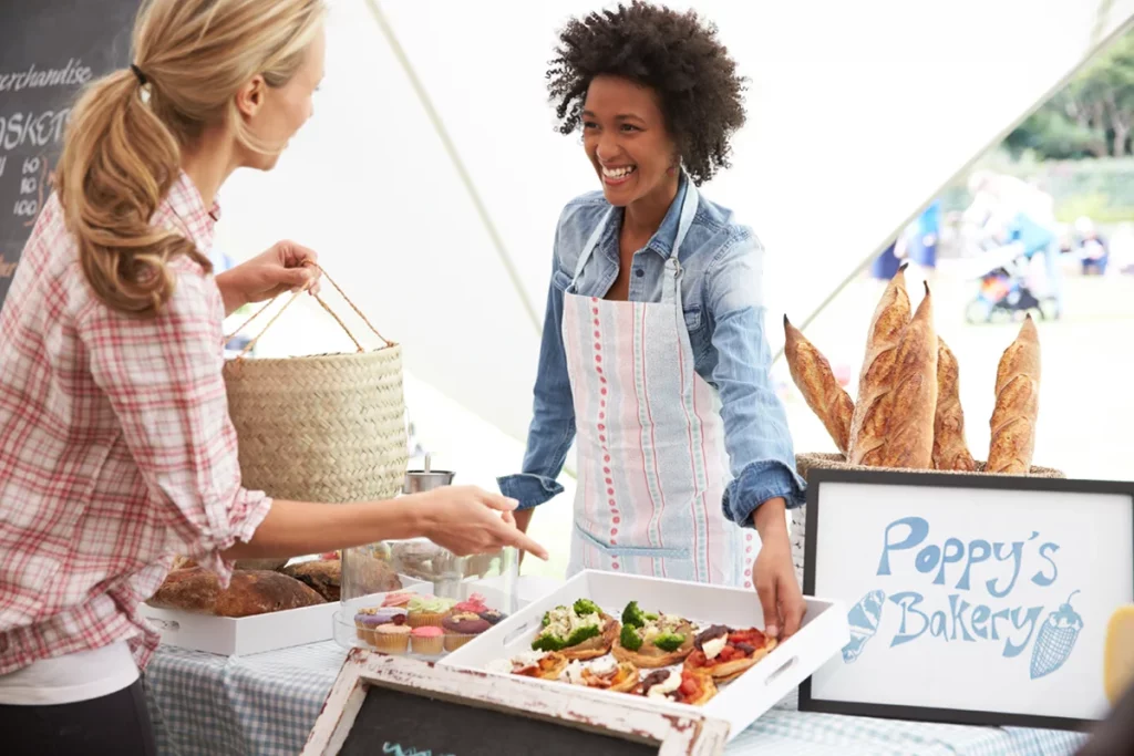 A vendor sales food at a market.