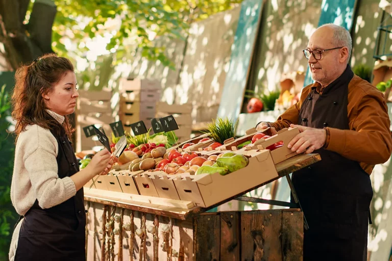 An event vendor sells fresh produce.