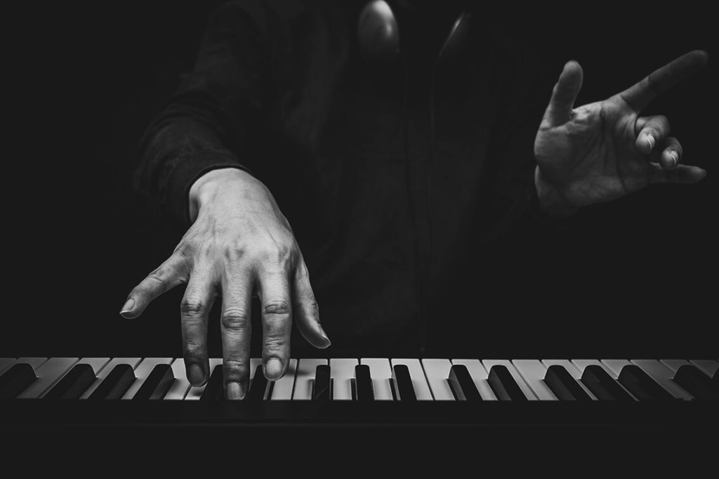 Black and white view of piano player