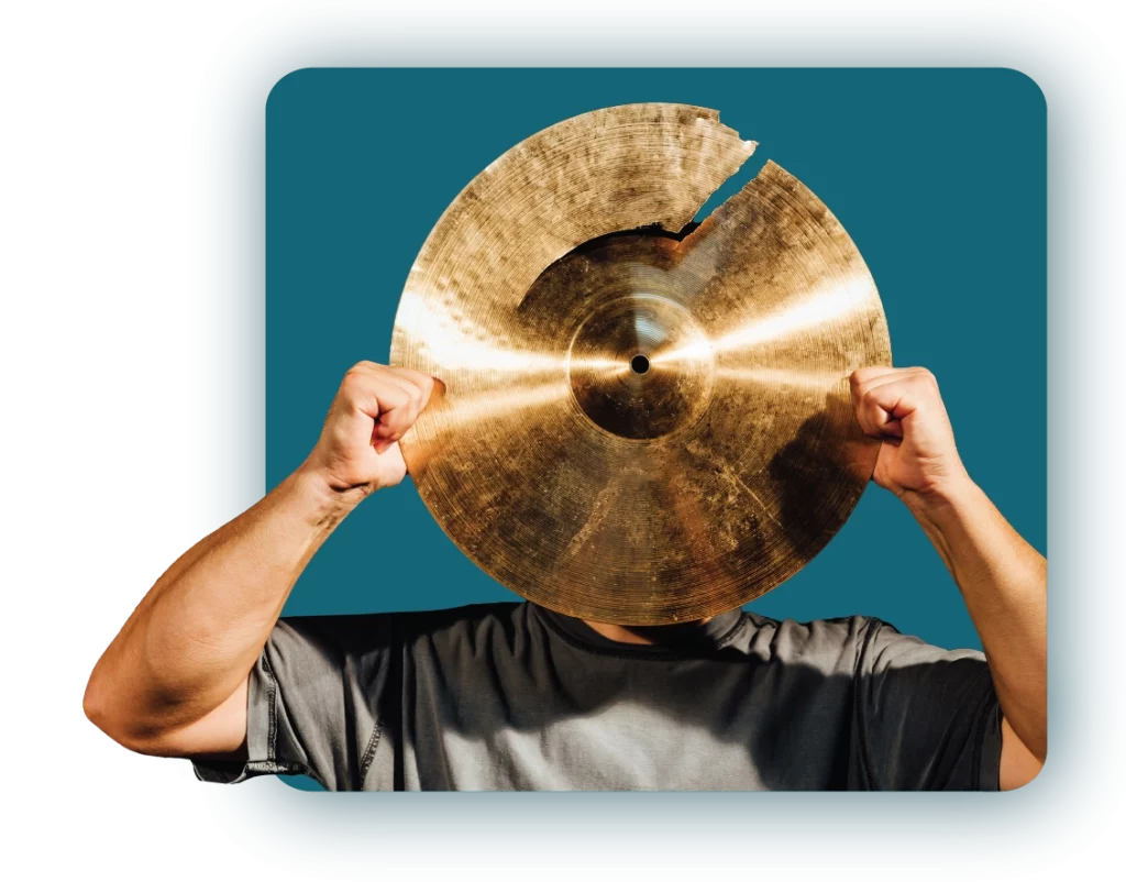 Person holding broken cymbal