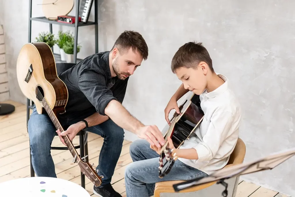 Guitar teacher with student