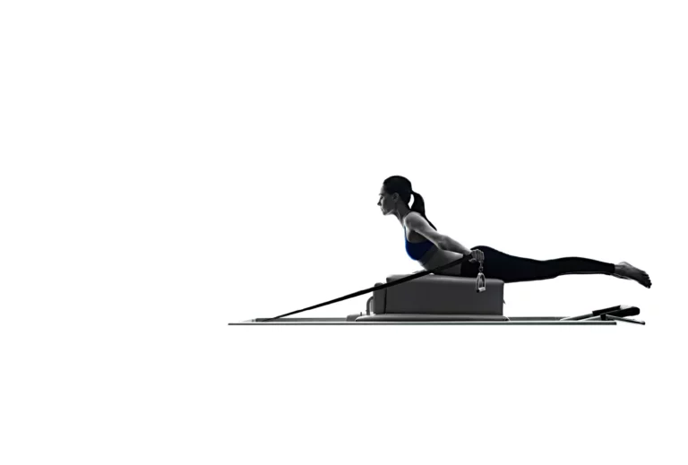 Black and white photo of a woman on a Pilates Reformer machine, in a prone position with arms pulling straps.