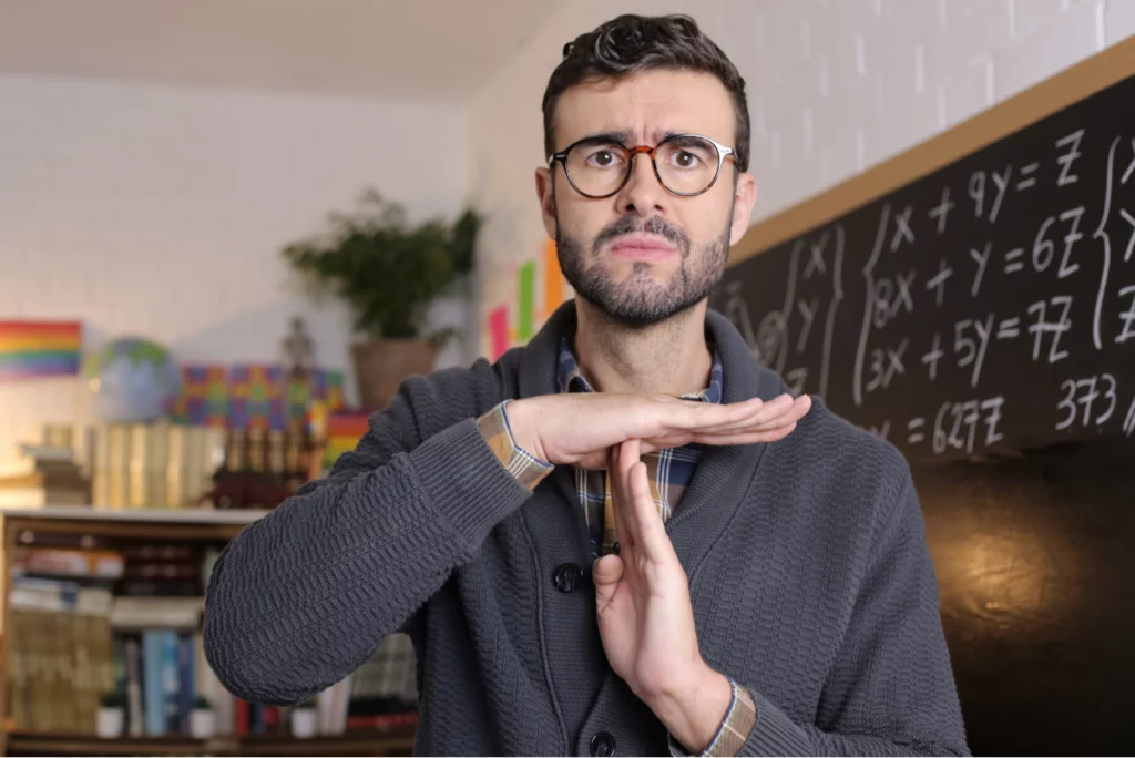 Concerned teacher making time out gesture