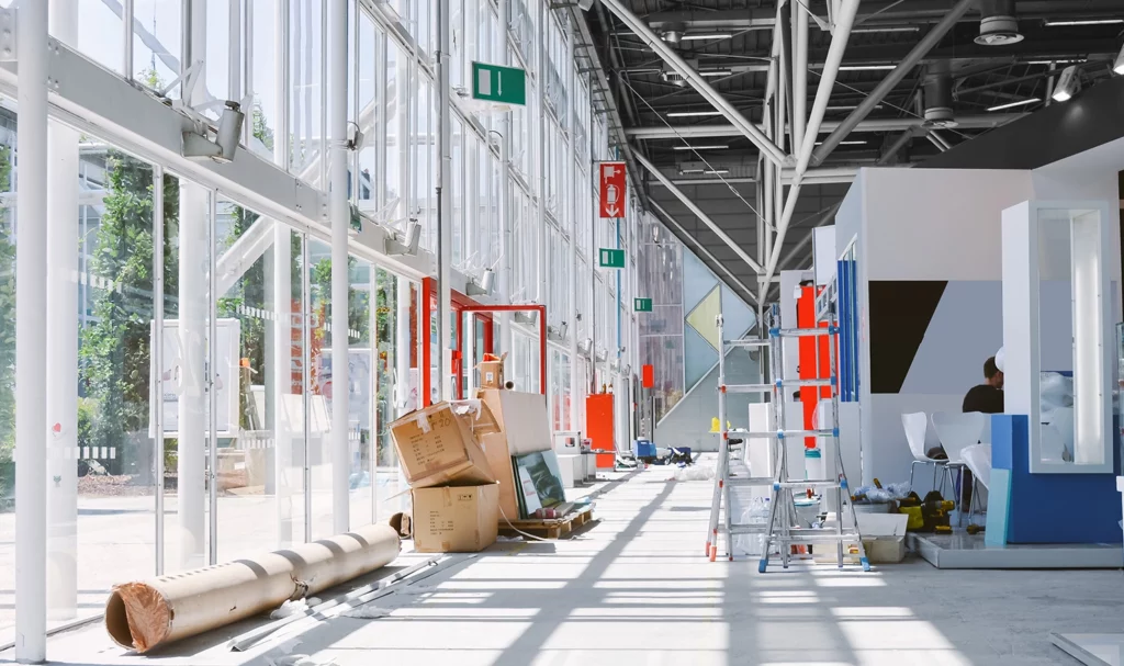 Building equipment and supplies lie in the hallway of a convention center as setup for an expo is underway.